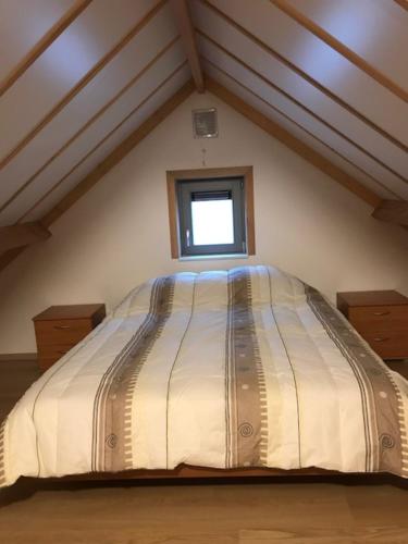 a large bed in a room with a window at Zeepark Mercator in Molenwijk