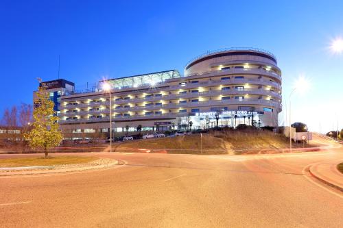 a large building with a road in front of it at Eurostars Madrid Foro in Tres Cantos