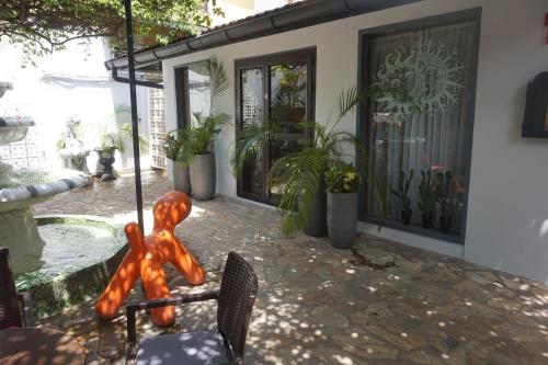 a statue of a person on a chair in front of a house at Hotel Le Griffon in Abidjan