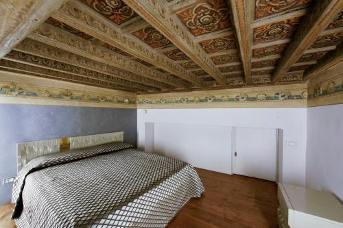 a bedroom with a bed and a coffered ceiling at Turin Art Experience in Turin