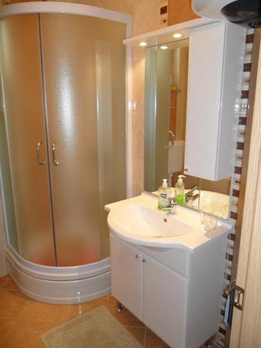 a bathroom with a sink and a shower at Apartmani Tomičić in Malinska