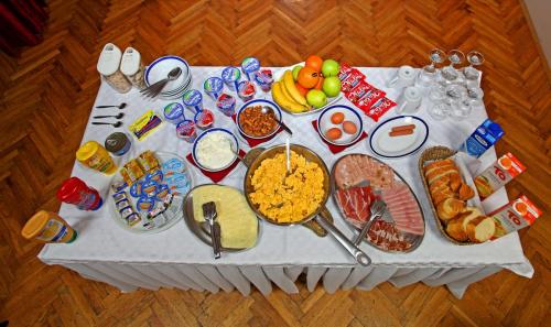 a white table with food on top of it at Rooms Lišnić in Osijek