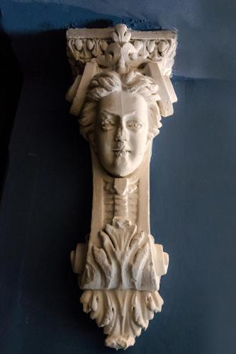 a white statue of a face on a wall at Tiflis Inn Boutique Hotel in Tbilisi City