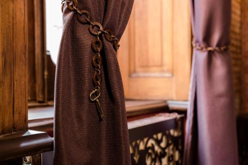 a curtain tied to a window with a chain at Tiflis Inn Boutique Hotel in Tbilisi City