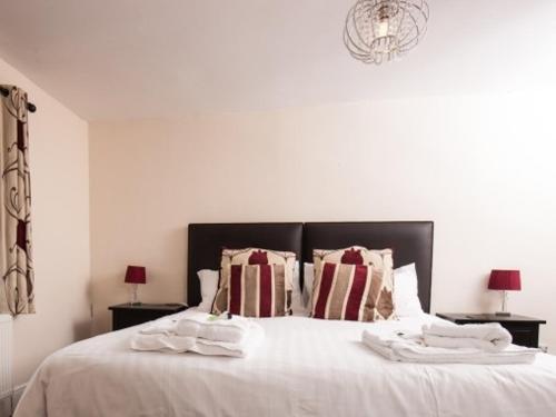 a bedroom with a white bed with towels on it at Bridge Hotel Brandon in Brandon