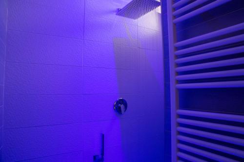 a purple bathroom with a shower with a purple light at Penisola Apartment in Vico Equense