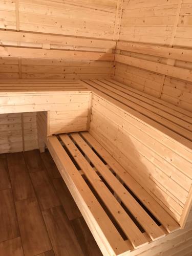 a small wooden sauna with a wooden floor at Smiley Rooms in Avrig