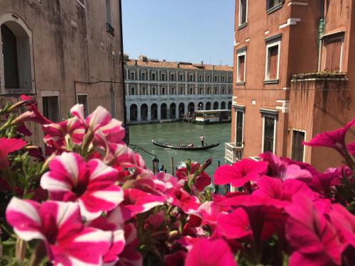 a view of a canal with a boat in the water at Palazzo Lion Morosini - Check in presso Locanda Ai Santi Apostoli in Venice
