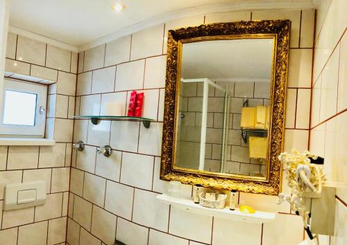 a bathroom with a mirror and a sink at Hotel Mariahilf München in Munich
