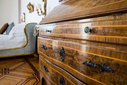 a wooden chest in a bedroom with a bed at Imperiale Palace Hotel in Santa Margherita Ligure