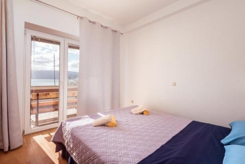 Marinus Apartments tesisinde bir odada yatak veya yataklar