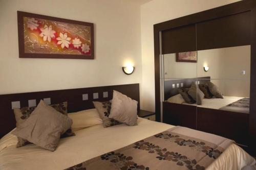 a bedroom with two beds and a large mirror at Dar Khayam in Hammamet