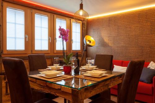a dining room with a wooden table and chairs at Schnapskeller in Zermatt
