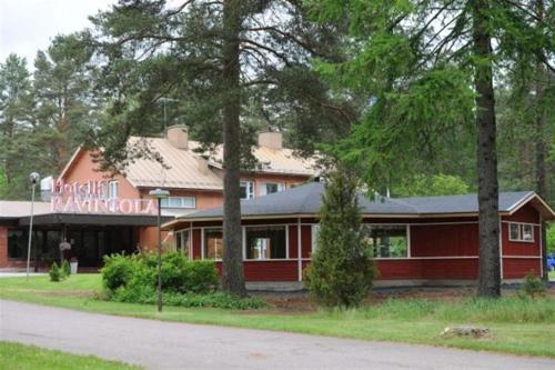 a red building with a sign for a restaurant at Otsolan Hovi in Humppila