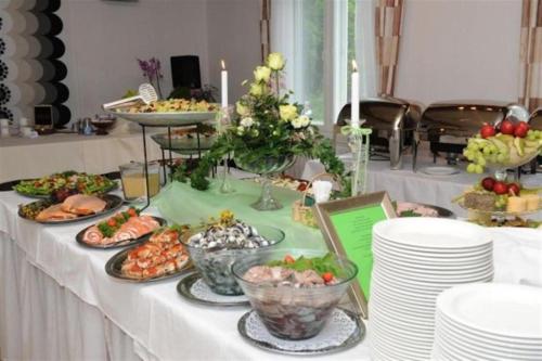 a table with plates of food on top of it at Otsolan Hovi in Humppila