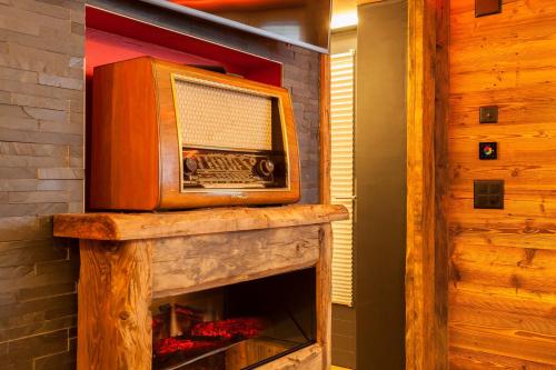 a television on top of a fireplace in a room at Schnapskeller in Zermatt