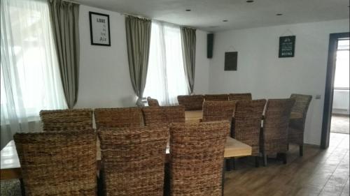 a dining room with a table and chairs at Smiley Rooms in Avrig