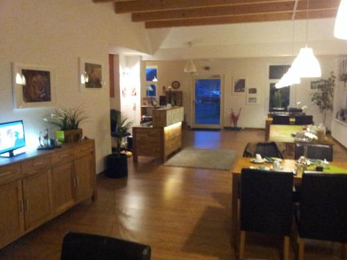 a large living room with a table and a couch at Hotel Rutherbach in Essen