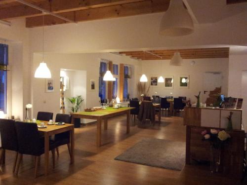 a living room with a table and a dining room at Hotel Rutherbach in Essen