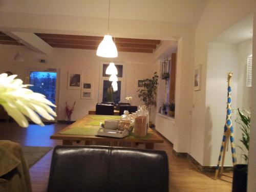 a living room with a table and a chair at Hotel Rutherbach in Essen