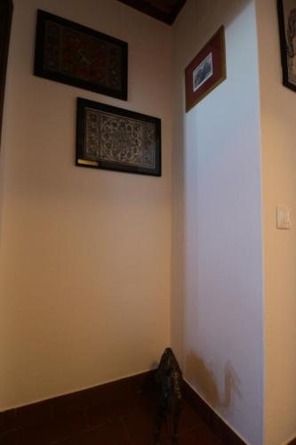 a corner of a room with paintings on the wall at The Place at Evoramonte in Évora Monte