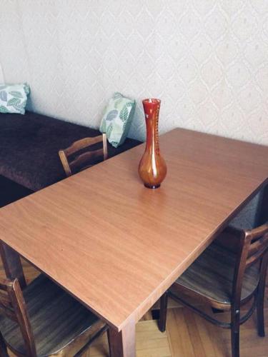 a vase sitting on top of a wooden table at Guesthouse Raisa in Kvareli
