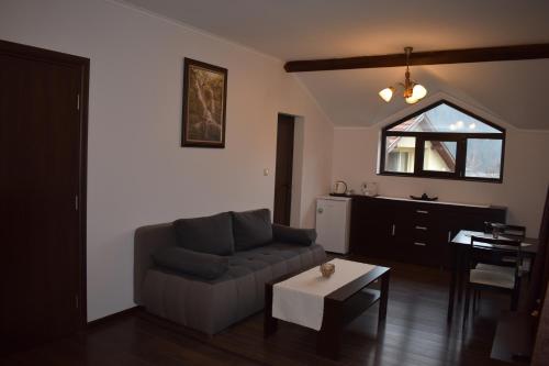 a living room with a couch and a table at Bavaria House in Govedartsi