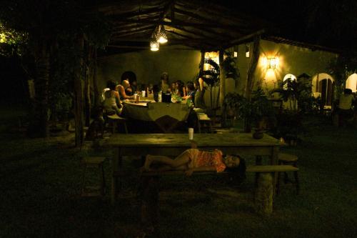 a person laying on a picnic table at night at Pousada Maresia in Atins