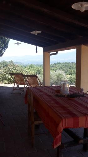 a table and chairs on a porch with a view at Bioagriturismo Poderaccio in Incisa in Valdarno
