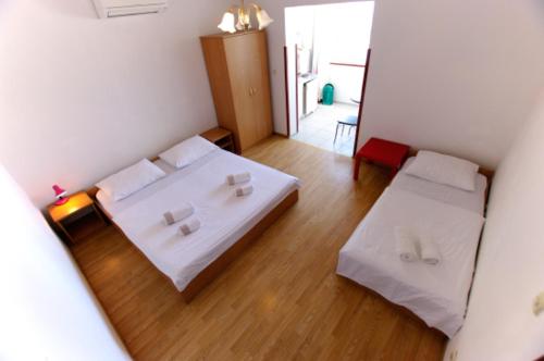 a small room with two beds and a hallway at Slanica studio ID 816 by HeartofDalmatia in Murter