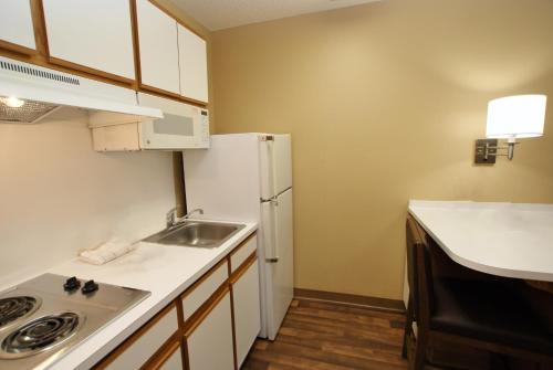 a small kitchen with a sink and a refrigerator at Extended Stay America Suites - San Diego - Sorrento Mesa in Sorrento