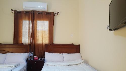 Postel nebo postele na pokoji v ubytování Royal Pyramids Inn