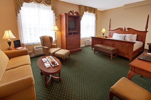 a hotel room with a bed and a living room at The Mimslyn Inn in Luray