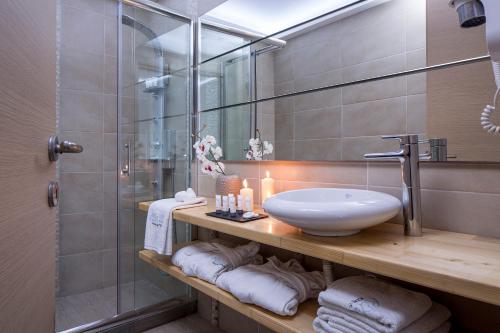 a bathroom with a sink and a shower at Callia Retreat Suites - Adults Only in Fira