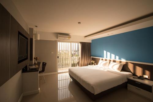 Ліжко або ліжка в номері Napatra Hotel