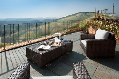 a patio with two wicker chairs and a table on a balcony at Villa Tiboldi in Canale