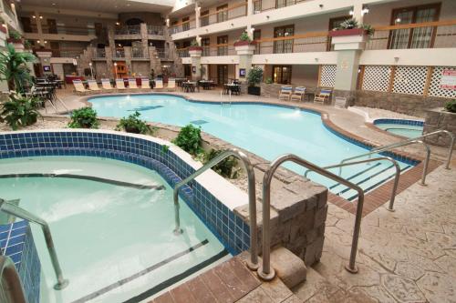 a large swimming pool in a hotel at Baymont by Wyndham Shakopee in Shakopee