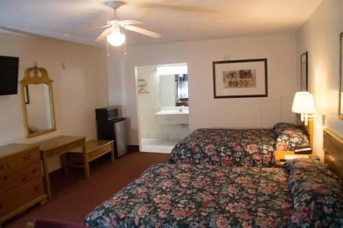 Un pat sau paturi într-o cameră la Tazewell Motor Lodge