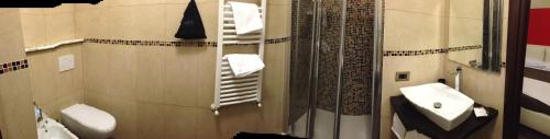 a bathroom with a sink and a toilet and a mirror at Le Divine La Terrazza in Levanto