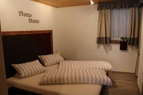 a couch with two pillows in a room at Ferienhaus Höll in Russbach am Pass Gschütt