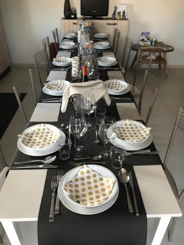 a long table with black and white plates and silverware at B&B La Via di Casa in San Leone