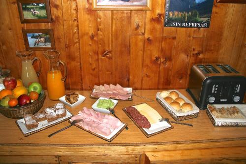 a table topped with different types of food at Lodge El Mirador De Guadal in Puerto Guadal