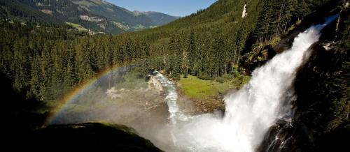 an aerial view of a waterfall with a rainbow at Appartment Sonnenschein in Uttendorf