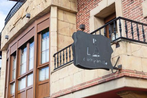 a sign on the side of a building at Pensión la Campanilla in La Penilla