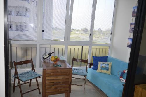 a living room with a couch and a table and chairs at Montehugh in Larnaka