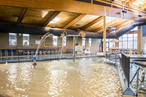 a pool of water in a gym with a water slide at Abe Martin Lodge & Cabins in Nashville