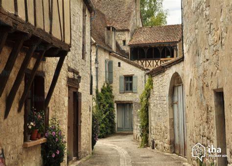an alley in an old town with stone buildings at Gîte "le pitous" in Cahuzac