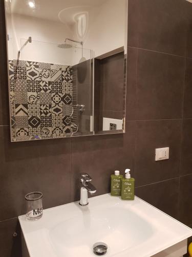 a bathroom with a sink and a mirror at Bsuites Scrovegni in Padova