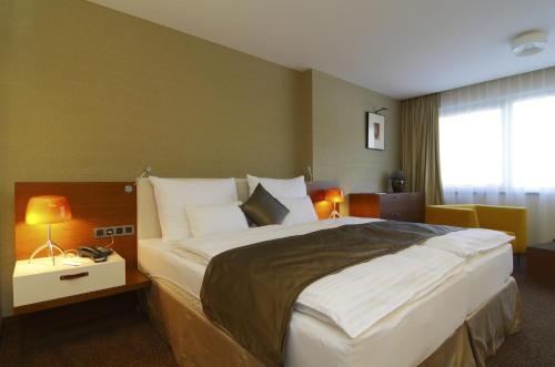 Postel nebo postele na pokoji v ubytování Mikado Hotel