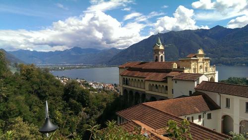 a view of a city with a church and a lake at Rooms Al Festival in Locarno